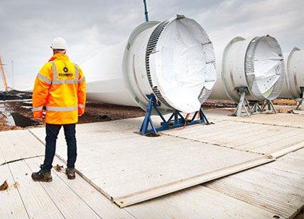 Engineer Stood Next To Wind Turbines Lay Flat