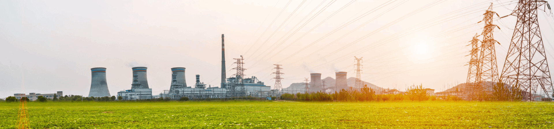 Sunset view of power station next to field