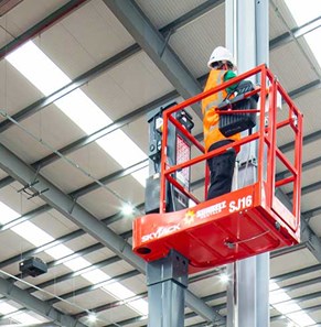 Man Standing On Low Level Access Platform On Site At A Sigma Retail Solutions Location In Warehouse