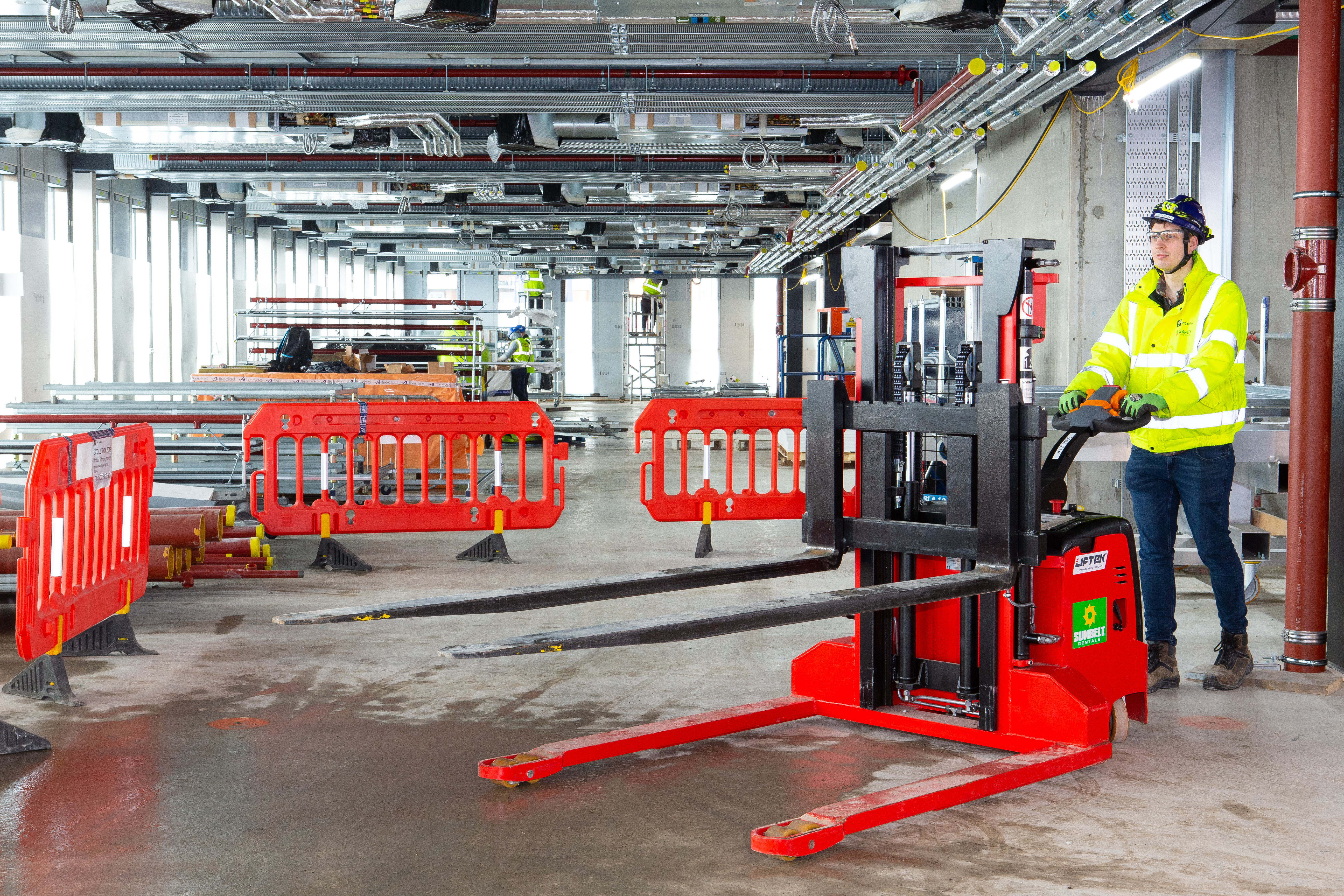 Custom Pallet Fork Truck Being Pushed In Warehouse By Worker